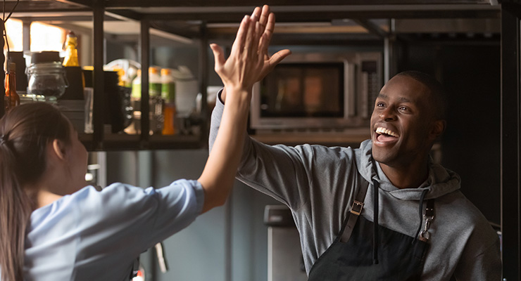 restaurant workers high five