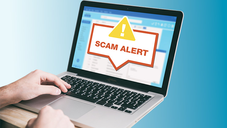 laptop with scam alert message
