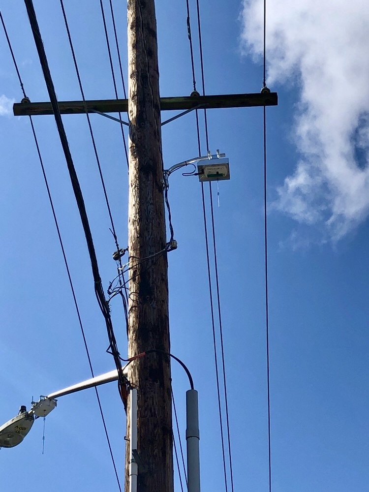 Device attached to utility pole