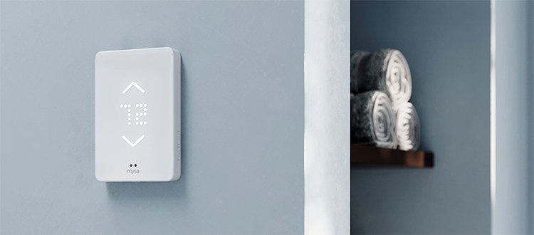 Mysa smart thermostat on home interior wall