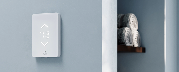 Mysa smart thermostat on home interior wall