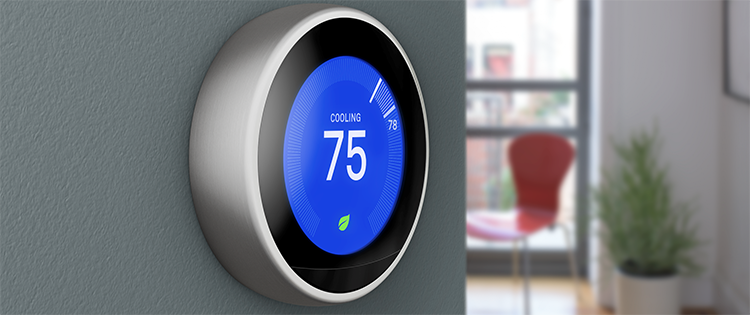 Nest thermostat on wall with digital temperature display, window, chair and houseplant in the background