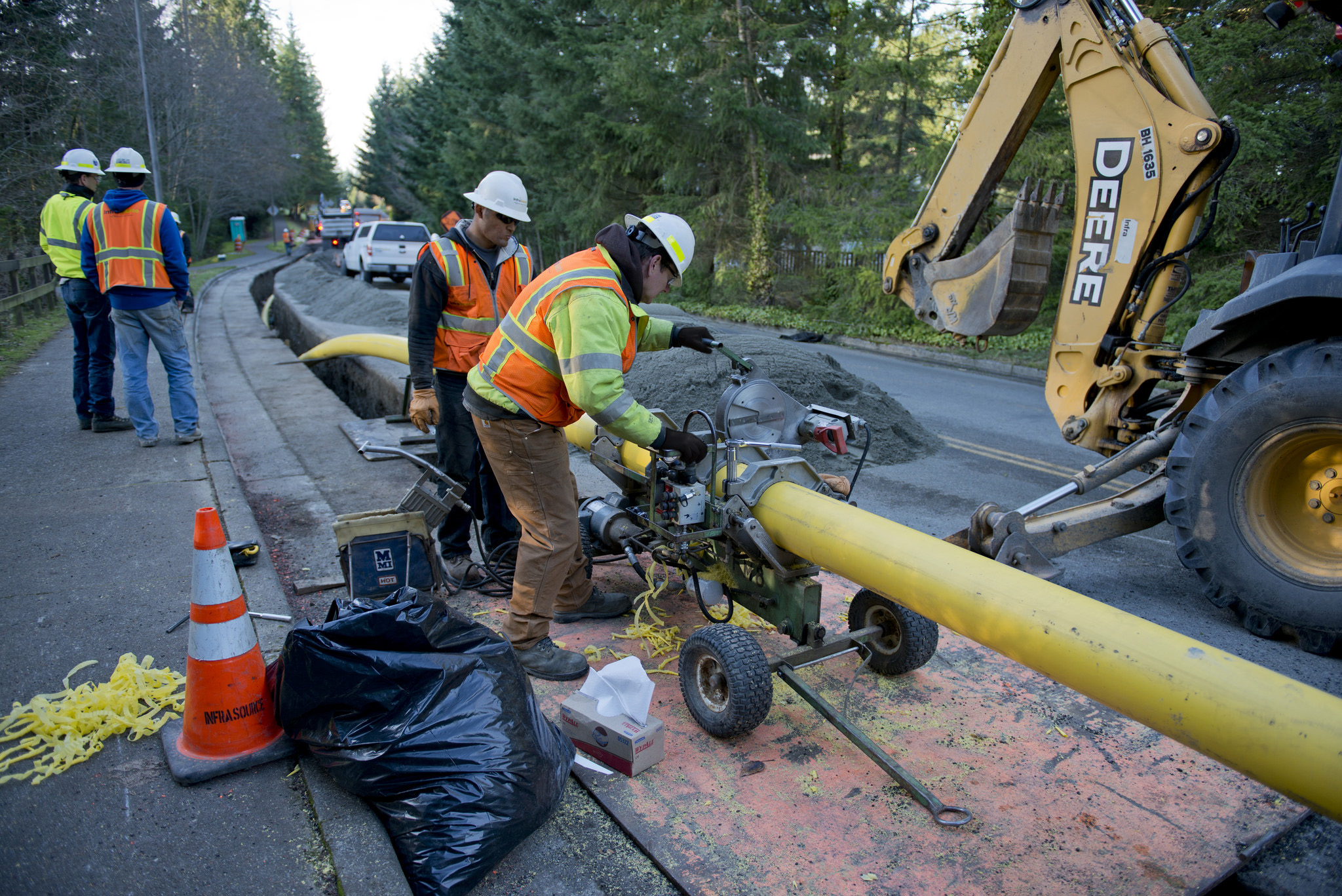 Construction workers laying new natural gas pipe