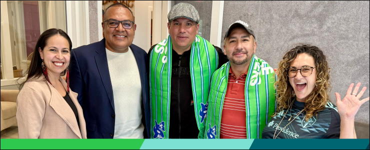 Smiling for the camera, a group of people who participated in a radio interview about the Sounders/PSE partnership