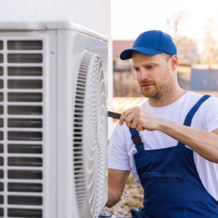Man Repairing a Heat Pump