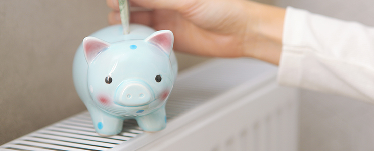 Dollar bill inserted into piggy bank