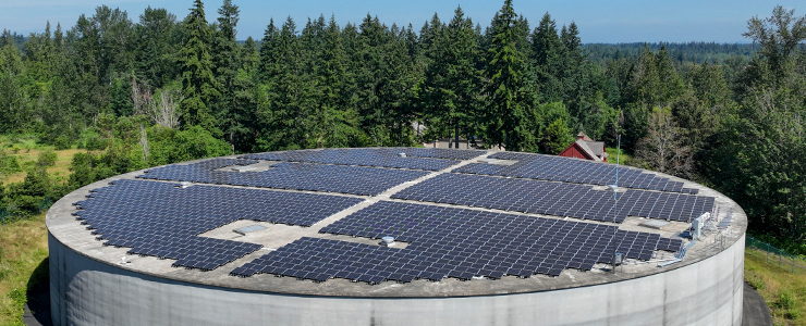 Aerial view of solar panels covering round concrete structure at Bonney Lake