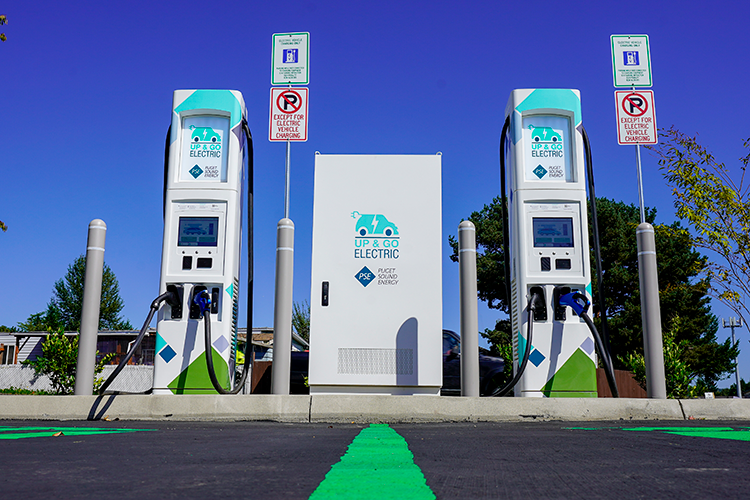 Two charging stations with PSE "Electric Up & Go" branding.