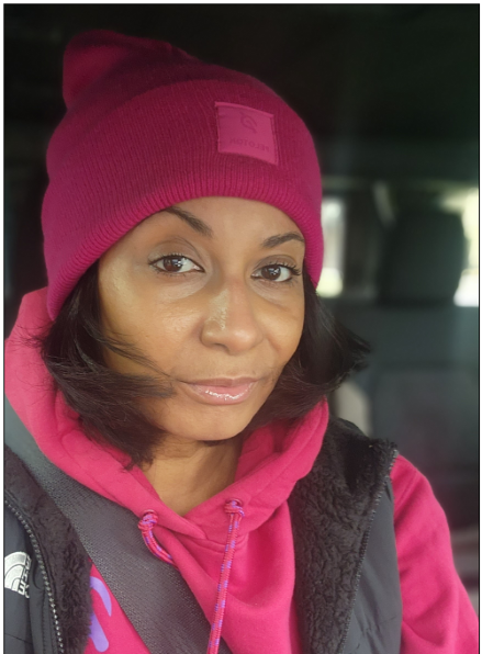 Hunter Hassig is shown wearing a bike helmet, standing with his bicycle, on a bike trail in the woods
