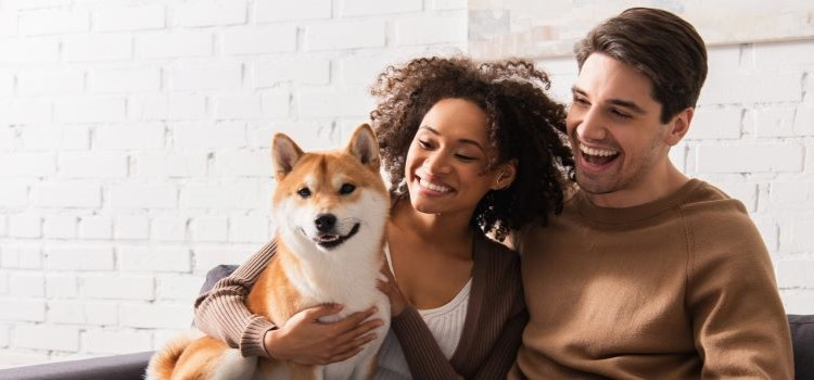 Smiling couple with dog