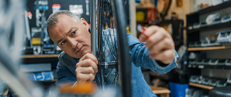 Mechanic repairing bicycle